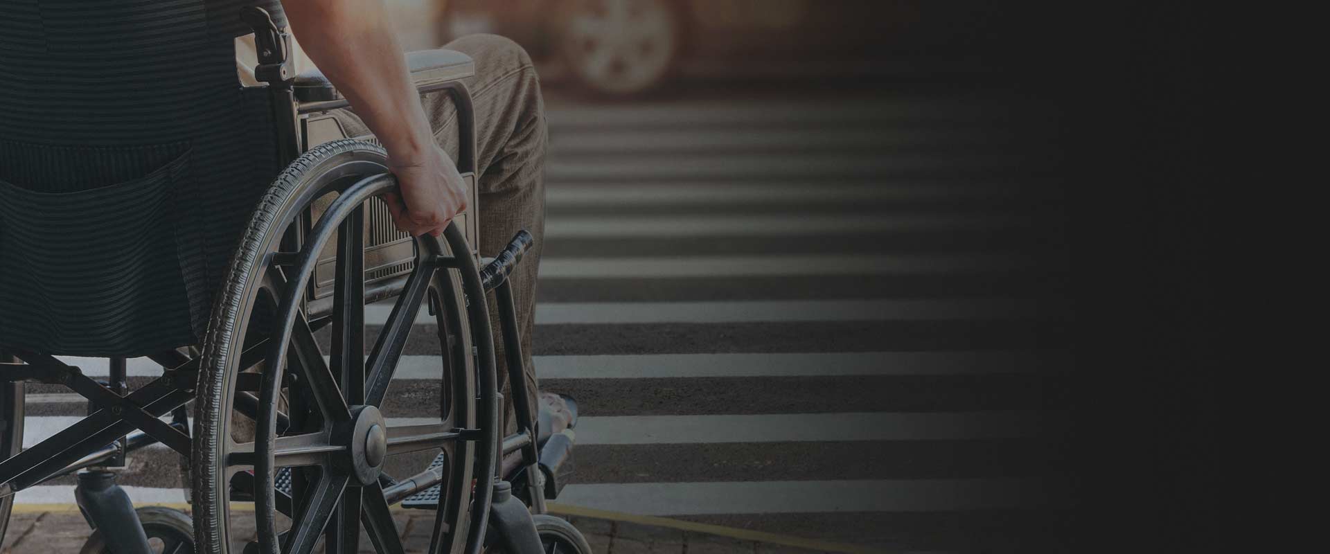 Person in a wheelchair about to cross a street