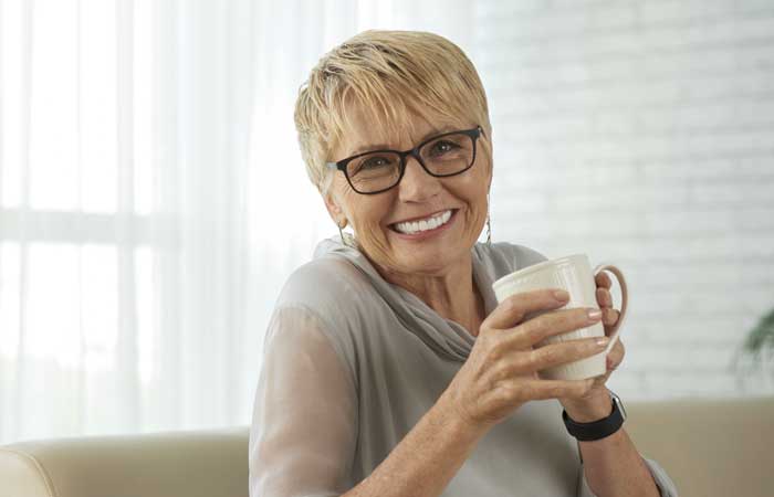 Smiling older woman holding a mug