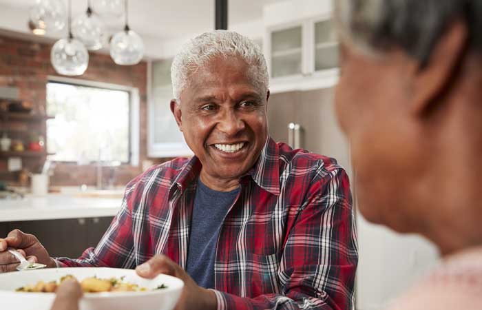 Older man smiling at the dinner table